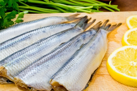 Raw herrings on wooden boardの写真素材