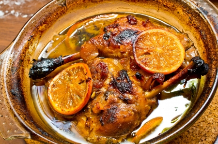 Ducks legs in oranges and other fruitsの写真素材