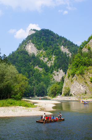 DUNAJEC RIVER, POLAND - AUGUST 11, 2015: traditional boat during the rafting. It is one of oldest and most famus entertainments in Poland.のeditorial素材