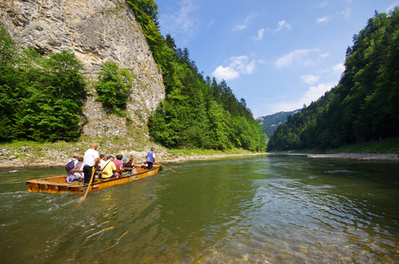 DUNAJEC RIVER, POLAND - AUGUST 11, 2015: traditional boat during the rafting. It is one of oldest and most famus entertainments in Poland.のeditorial素材