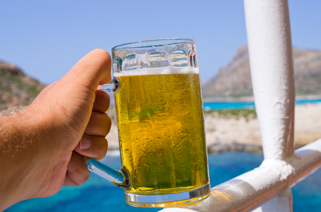 Glass of cold beer in tropical climateの写真素材
