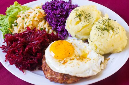 Typical polish breaded steak with eggの写真素材