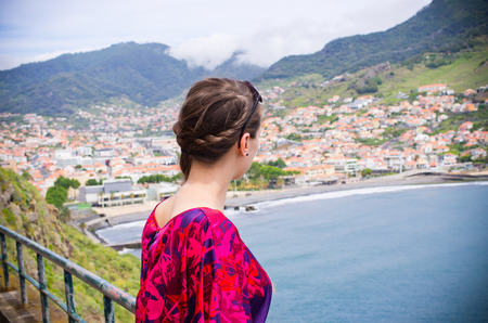 Young woman looking on Machico town, Madeira island, Portugalの写真素材