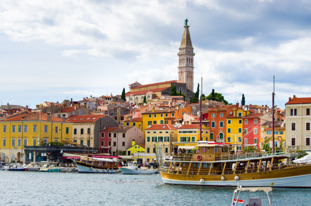 Discover Rovinj! Its colorful buildings, historic church, and coastal views create a charming Mediterranean atmosphere. Perfect for travel and tourism campaigns.の写真素材