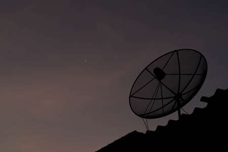 Satellite dish on the roof in eveningの写真素材