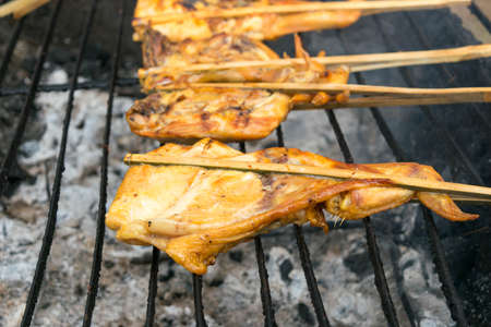 roasting chicken on the grillの写真素材