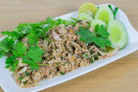 Spicy minced pork on wood table, Thai food.の写真素材
