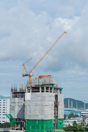 Building crane, engineering and building skyscraper under constructionの写真素材