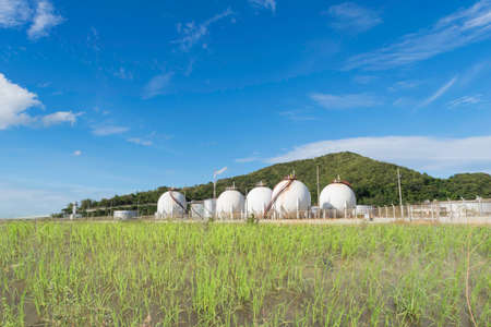LPG gas storage sphere tanks with paddy in Thailandの写真素材