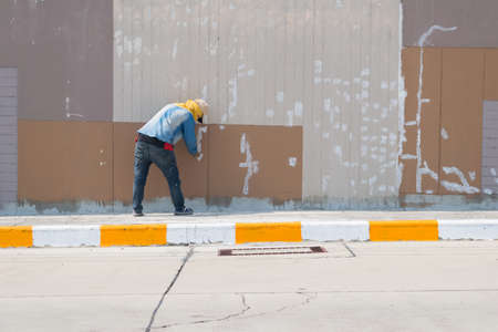 Fracture of wall is repaired by workerの写真素材