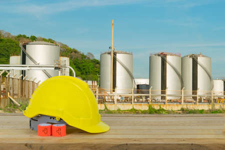 Oil refinery industry and yellow Safety Helmet with blue sky backgroundの写真素材