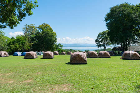 camping tent in front of river and mountain in Thailandの写真素材