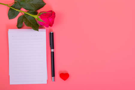 Many small heart in heart box with pink roses, note with pen on pink color backgroundの写真素材