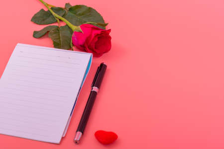 Many small heart in heart box with pink roses, note with pen on pink color backgroundの写真素材