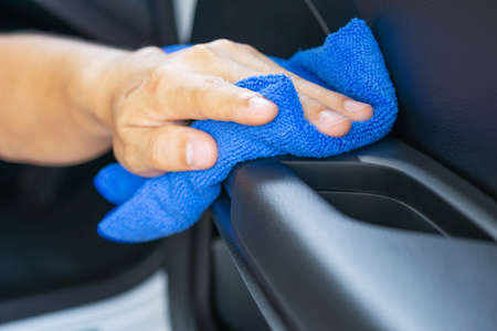 Closeup for man polishing cleaning car with microfiber clothの写真素材