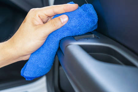 Closeup for man polishing cleaning car with microfiber clothの写真素材