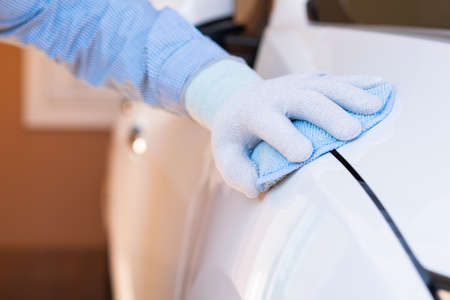 Closeup for man polishing cleaning car with microfiber clothの写真素材