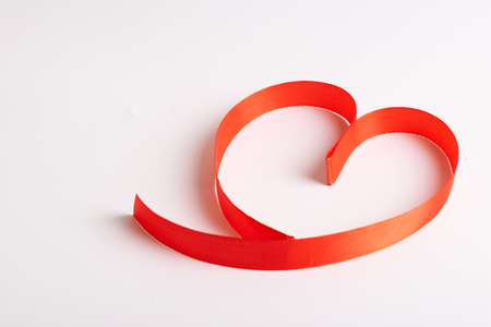 Red hearts from ribbons on a white backgroundの写真素材