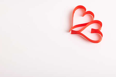 Red hearts from ribbons on a white backgroundの写真素材