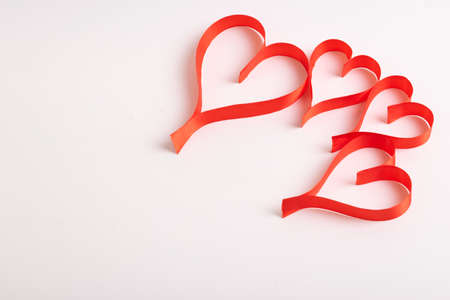 Red hearts from ribbons on a white backgroundの写真素材