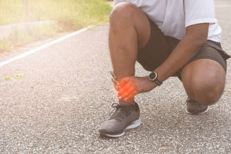 Sore ankle, man injury ankle pain after training running workout, Healthcare Conceptの写真素材