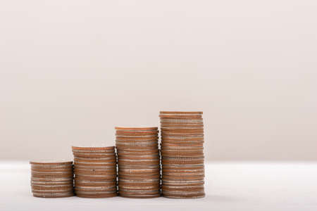 Hand putting coins on stack on table,Saving money concept or Business Growth conceptの写真素材