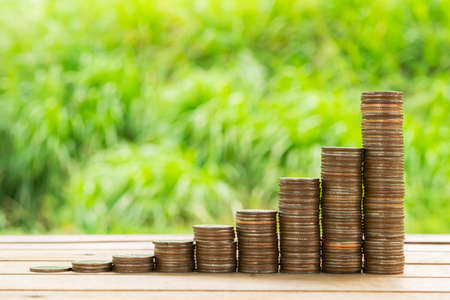 Stack money coins in green bokeh background. Money laundering. Business Growth concept. Coins stack