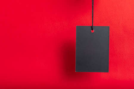 Black friday sale concept. Black Sale tag color on the red background with Copy space.の写真素材