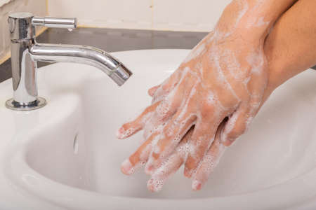 Man washes his hands with soap at home before and after do activity to prevent coronavirus...
