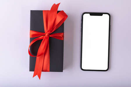 Black Friday concept or Black Christmas box with smartphone.の写真素材