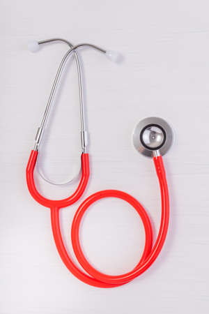 Red heart with Red stethoscope isolated on white wood background. Medical concept, Health care concept.の写真素材