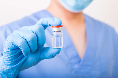 Covid-19 vaccine disease preparing, Doctor or scientist holding liquid vaccines.Concept fight...