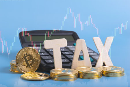 Tax BTC cryptocurrency with TAX wording in front of calculator on blue backgroundの写真素材