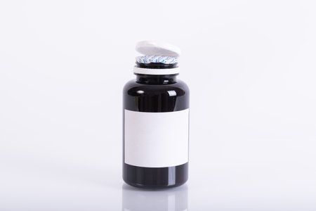 close up of medicine pills bottle on white backgroundの写真素材
