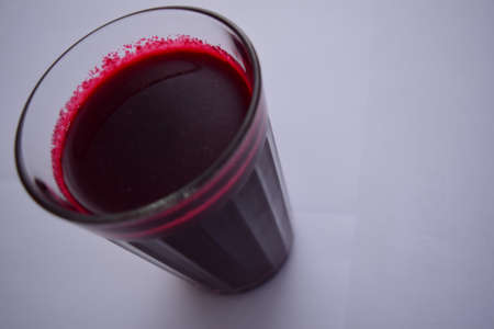 The red juice in the glass.