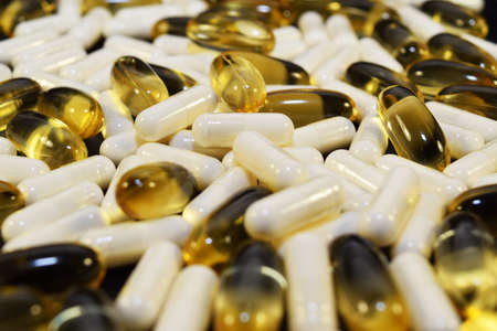Different pills, white and yellow.