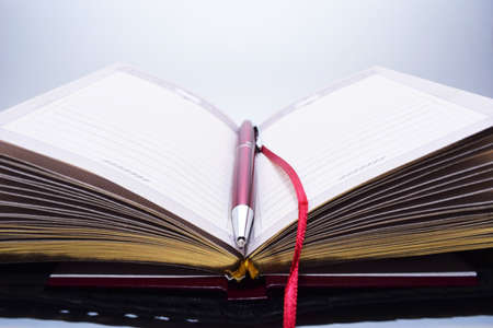 Blank notepad and pen on office white blur background. Business concept with copy space and place...