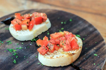 tomato Bruschetta on wooden dishの写真素材