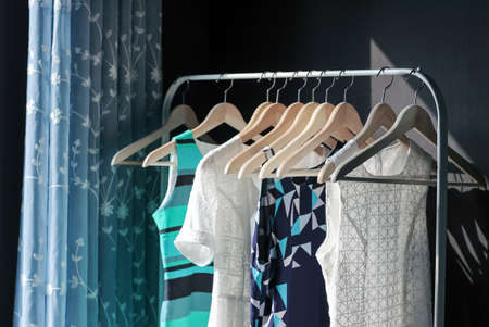 female clothes hanging in a rowの写真素材