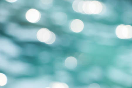 blurry light spots on blue oceanの写真素材