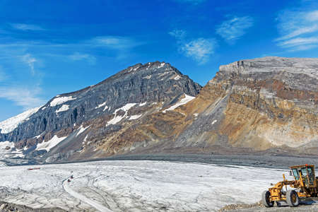 Snow on grassland under mountainsの写真素材