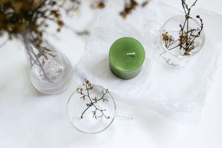 candle with flower vase on tableの写真素材