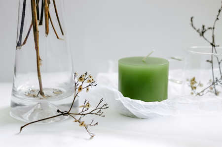 candle with flower vase on tableの写真素材