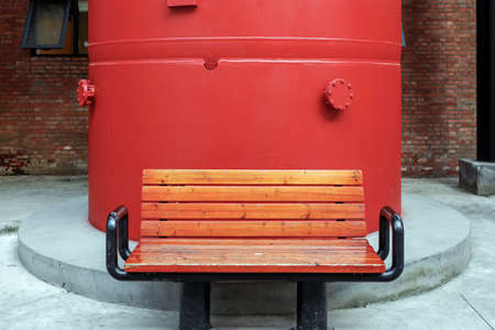 bench with red pipe in factoryの写真素材