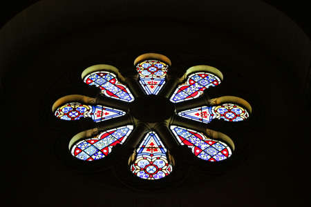 colorful glass church window in darkness