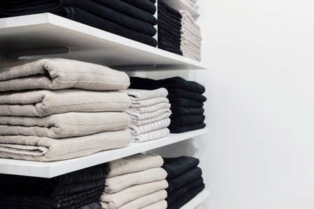 a pile of towels on shelfの写真素材
