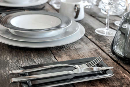 dishes and cutlery on wooden table