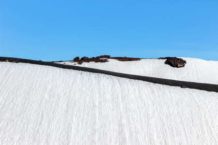 snow on crater on mount etnaの写真素材