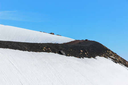 snow on crater on mount etnaの写真素材