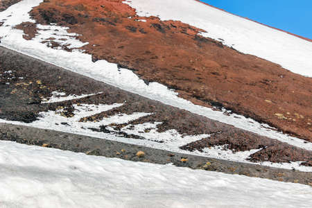 snow on lava stone on mount etnaの写真素材